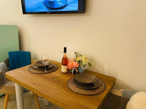 a wooden table with two hats and wine glasses on it at Agriturismo Le Tese in Colà di Lazise