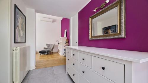 a white dresser in a room with a purple wall at Apartment Iriska in Novigrad Istria