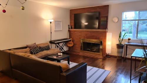 a living room with a couch and a fireplace at Startup House Palo Alto in Palo Alto
