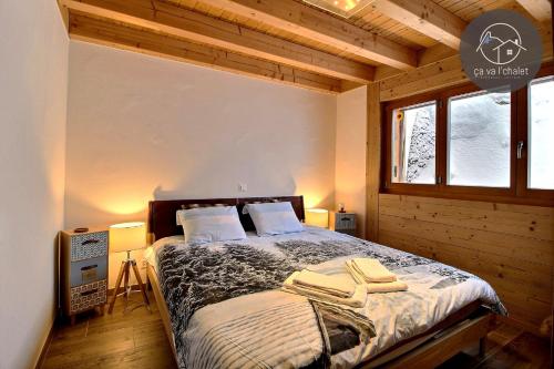 una camera da letto con un letto e due asciugamani di Chalet de charme l'O a Ovronnaz