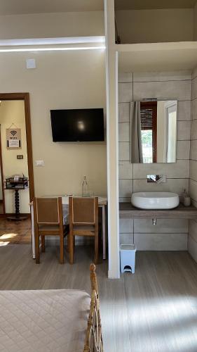 a bedroom with a bathroom with a tub and a sink at Casa Don Vicenzo in Randazzo