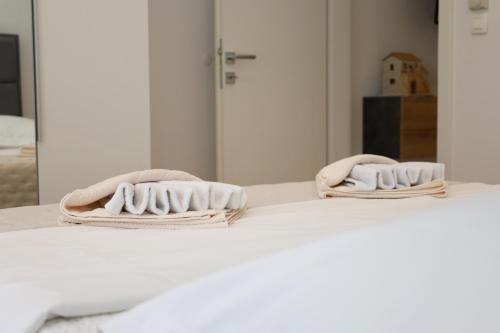 two towels sitting on top of a bed at Dalmata D in Podstrana