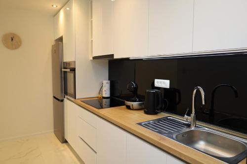 a kitchen with a sink and a counter top at Dalmata D in Podstrana