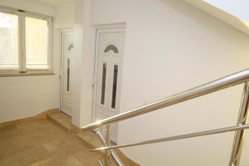 a staircase with a white door in a room at Dalmata D in Podstrana