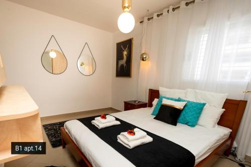 a bedroom with a bed with towels on it at Palmore Resort apartments in Eilat