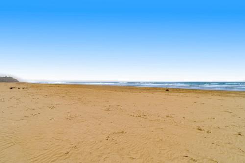 a beach with footprints in the sand and the ocean at ShellSeeker in South Beach
