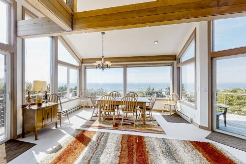 a dining room with a table and chairs and large windows at ShellSeeker in South Beach