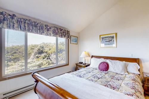 a bedroom with a bed and a large window at ShellSeeker in South Beach