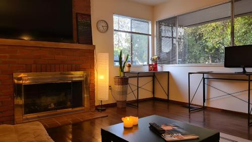 a living room with a fireplace and a tv at Startup House Palo Alto in Palo Alto
