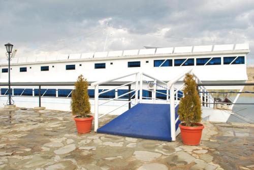 a boat with two potted trees in front of it at Hotel Brod Panini Veles in Veles