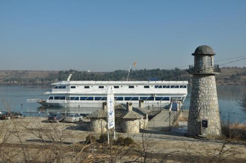 a large boat on the water with a lighthouse at Hotel Brod Panini Veles in Veles