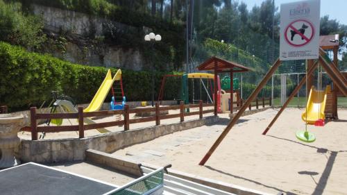 a playground with slides and play equipment in a park at Villaggio Elisena in Vieste