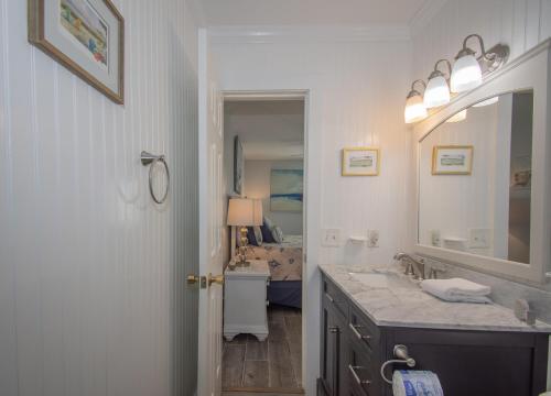 a bathroom with a sink and a mirror at 187 Beach Club Villa in St. Helena Island