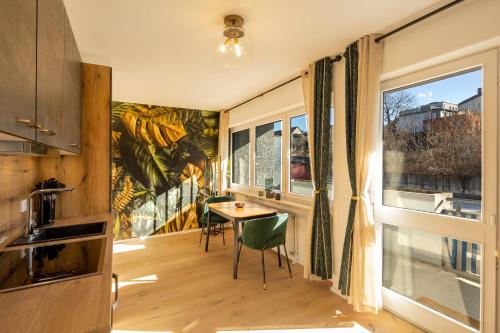 a kitchen with a table and a window at SweetHome - Luxus pur - Küche, Balkon, WiFi in Dachau