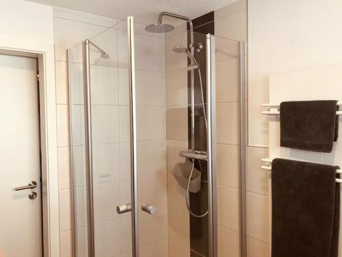 a shower with a glass door in a bathroom at Ferienhaus Geiger in Bernau im Schwarzwald in Bernau im Schwarzwald