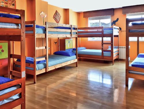 a room with four bunk beds in a room at Meiga Backpackers Hostel in Santiago de Compostela