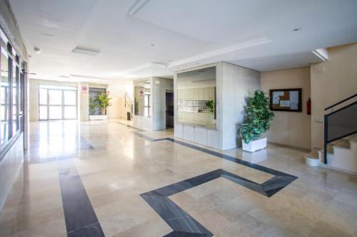 an empty lobby with plants in a building at ESPACIO 5 - Primera Línea de Playa in Cullera