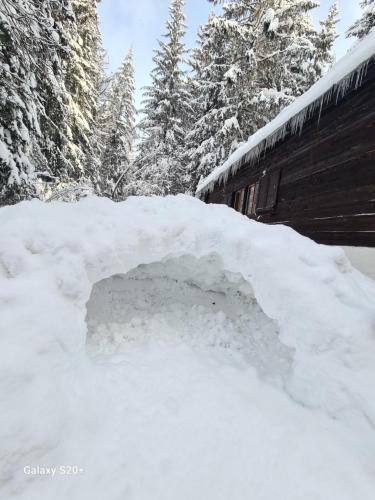 a pile of snow on the side of a building at Chata pri Veľkej Rači in Oščadnica