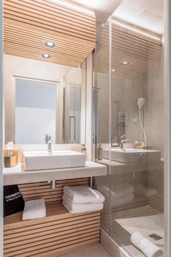 a bathroom with a sink and a shower at La Cachette, Friendly Hotel & Spa in Arc 1600