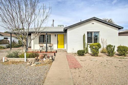 a white house with a yellow door at Lovely Tucson Home about Walk to Reid Park Zoo! in Tucson