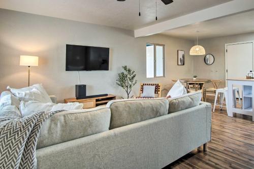 a living room with a couch and a table at Lovely Tucson Home about Walk to Reid Park Zoo! in Tucson