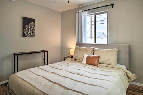a bedroom with a large bed with a window at Lovely Tucson Home about Walk to Reid Park Zoo! in Tucson