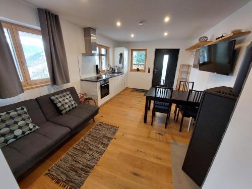 a living room with a couch and a table at Haus Ströhle in Schruns-Tschagguns