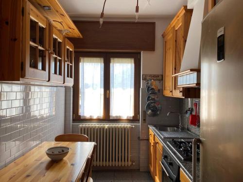 a kitchen with a wooden table and a radiator at Barzio Paradise in Barzio