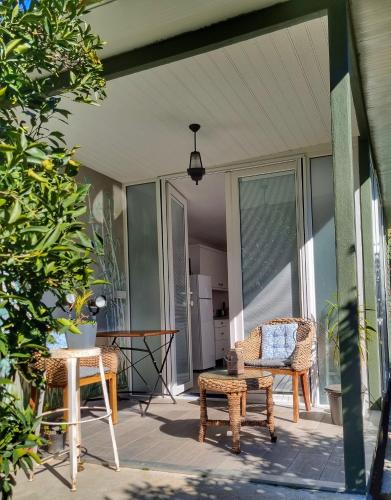 a patio with two chairs and a table on a porch at Portalimo Lodge Hotel - Adult Only +12 in Cıralı