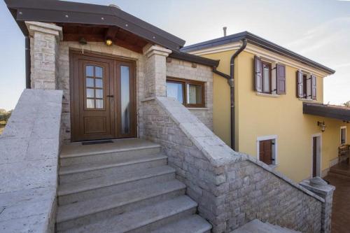 a house with stairs leading up to a door at Appartment Arrburoni in Novigrad Istria