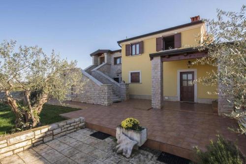a house with a patio in front of it at Appartment Arrburoni in Novigrad Istria