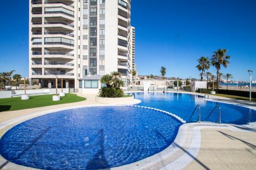 a large swimming pool in front of a building at ESPACIO 2 Primera LINEA DE PLAYA in Cullera