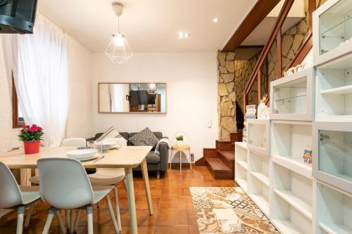 a dining room and living room with a table and chairs at Barcelona Beach Home in Barcelona