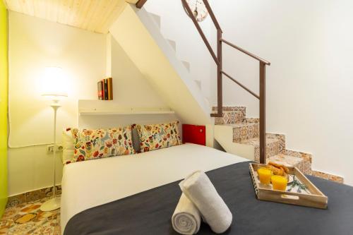 a bedroom with a bed with a tray of fruit on it at Almaden apartamento in Madrid