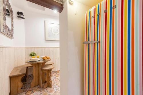 a room with a colorful refrigerator and a table at Almaden apartamento in Madrid