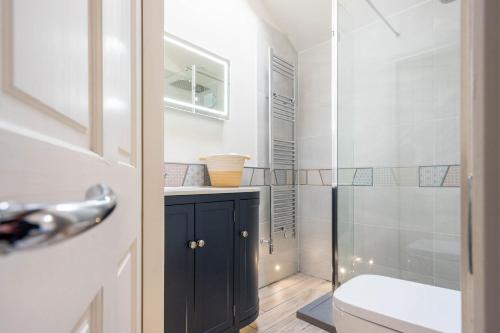 a bathroom with a shower and a sink and a toilet at Moatside Gate in York