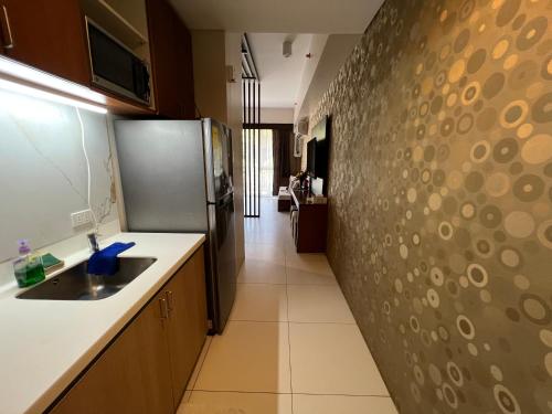 a kitchen with a sink and a wall at Bonel condo at Pico de Loro in Cutad