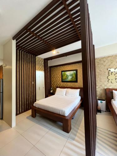 a bedroom with a bed in a room at Bonel condo at Pico de Loro in Cutad