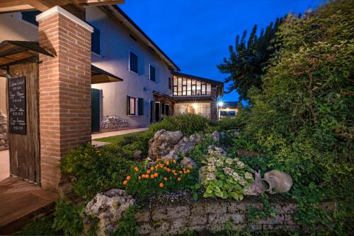 una casa con jardín frente a un edificio en Agriturismo Le Tese, en Colà di Lazise