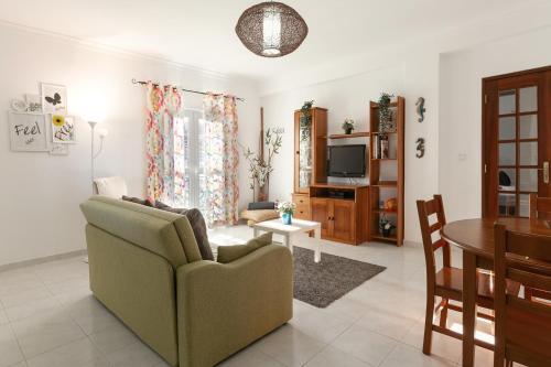 a living room with a couch and a table at Relax In Foz in Foz do Arelho