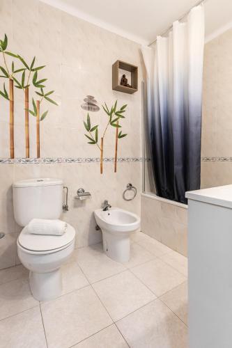 a bathroom with a toilet and a sink at Relax In Foz in Foz do Arelho