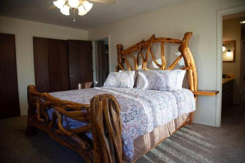 a bedroom with a wooden bed with a wooden frame at Spacious 4BR 3BA Convenient Downtown Driggs House in Driggs