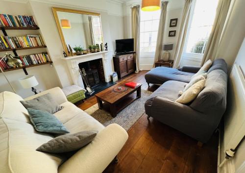 a living room with two couches and a fireplace at 3 Bedroom House, ST9, Ryde, Isle of Wight in Ryde