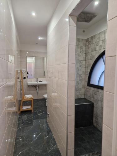 a bathroom with a sink and a toilet and a mirror at Comfort Zone Naples in Naples