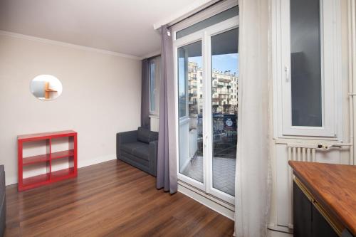 a living room with a large window and a couch at Charmant 3 Pièces - RER à 100 M in Arcueil