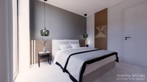 a bedroom with a large bed with white sheets at Stelios Gardens in Malia