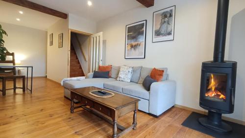 a living room with a couch and a fireplace at L'Oustal des amis in Belcaire