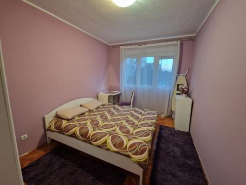 a small bedroom with a bed and a window at Your place in Podgorica in Podgorica