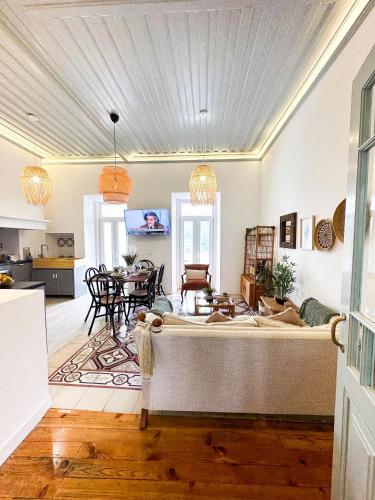 a living room with a large bed and a table at 4Cantos Alentejo in Mértola