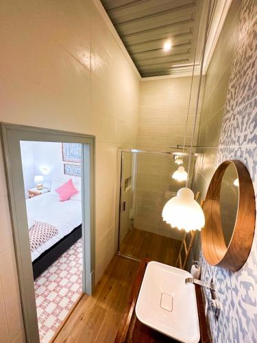 a bathroom with a sink and a mirror at 4Cantos Alentejo in Mértola